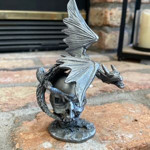 Silver colored metal dragon and skull statue